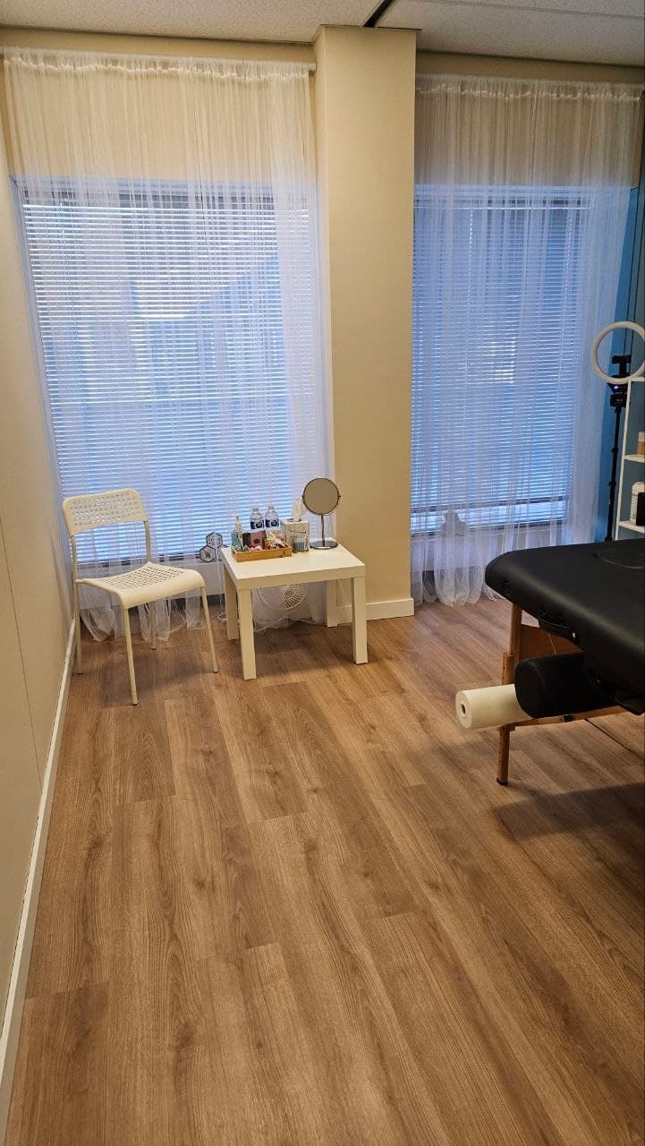 Oh, Honey studio consultation area with chair, table, and treatment bed